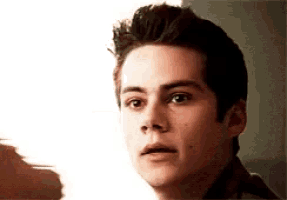 a close up of a young man 's face with a slight surprised look on his face .