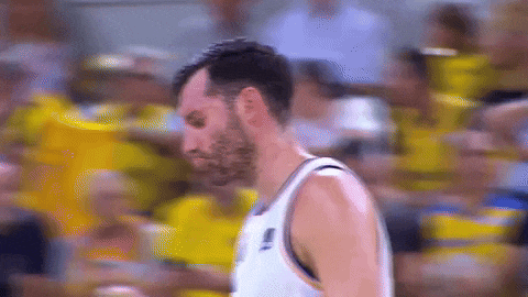 a man in a basketball uniform with the letter l on the front