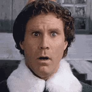 a close up of a man 's face with a surprised expression .
