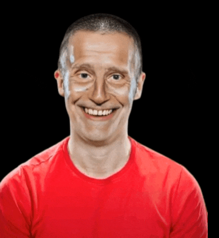 a man in a red shirt is smiling with a black background behind him