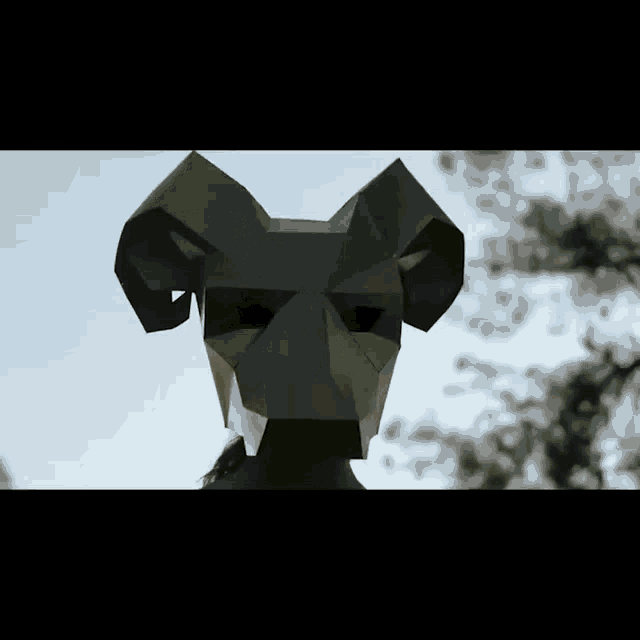 a person wearing a ram mask with horns