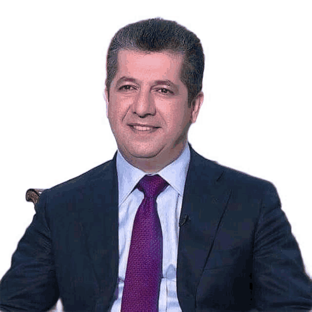 a man in a suit and tie is smiling and sitting in a chair .