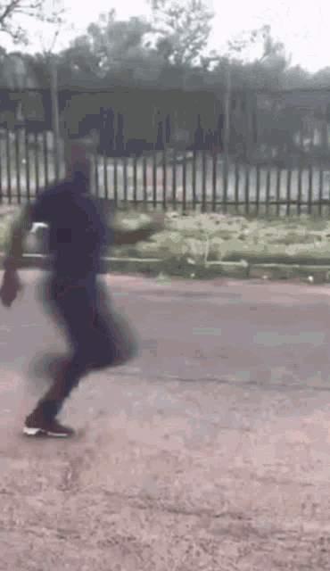 a blurry picture of a person walking down a road .