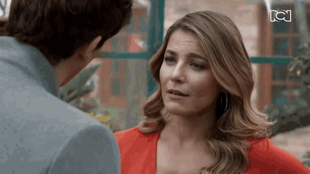 a man and a woman are looking at each other .