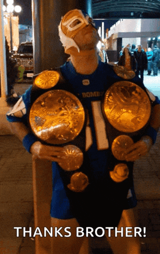 a man wearing a mask and holding a wrestling belt with the words thanks brother written below him