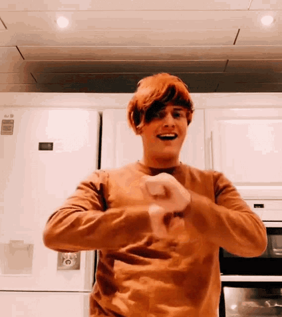 a man dancing in front of a lg refrigerator