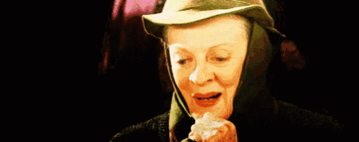 a woman wearing a hat and a green jacket is smiling .