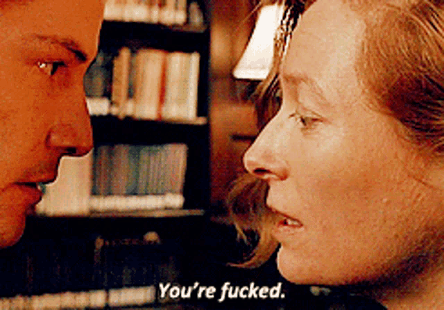 a man and woman are looking at each other and the woman is saying you 're fucked