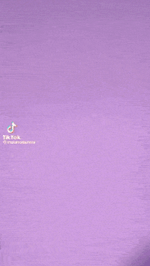 a tiktok video of a woman with purple hair against a purple background