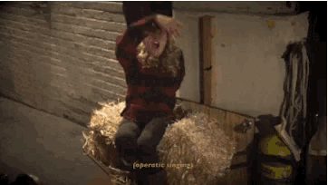 a person is sitting on a bale of hay with the words operatic singing written above them