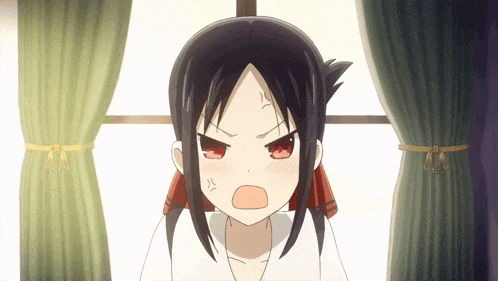 a girl with black hair and red eyes is making an angry face in front of a window