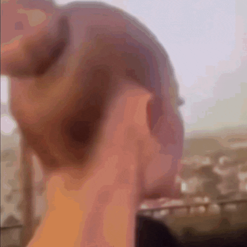 a close up of a person 's hand holding a remote control .