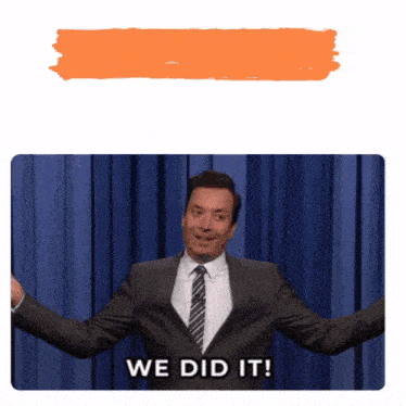 a man in a suit and tie says " we did it " on a stage