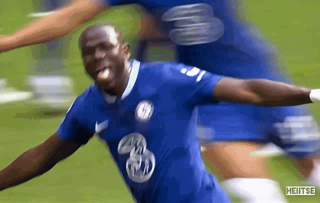 a soccer player wearing a blue jersey with the number 3 on it