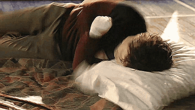 a man is laying on his stomach on a pillow .