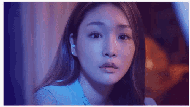 a close up of a woman 's face in a blue light