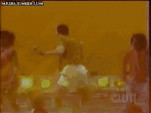 a group of people are dancing in front of a screen that says maxnet tumblr.com