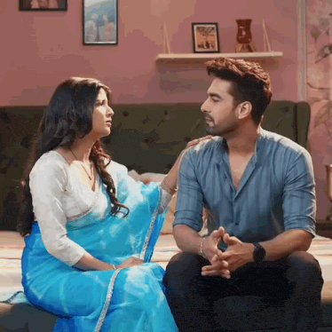 a man and a woman are sitting on a couch and talking