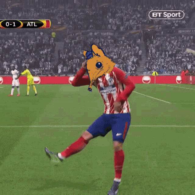 a soccer player is celebrating a goal with a fox head on his head