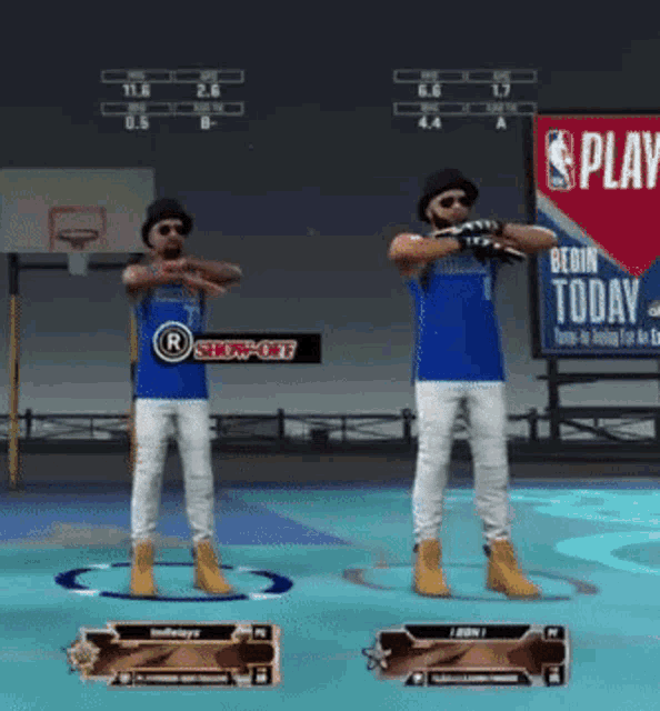 two men are standing on a basketball court in front of a sign that says " play "