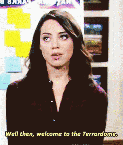 a woman says " well then welcome to the terrordome " in front of a wall of sticky notes