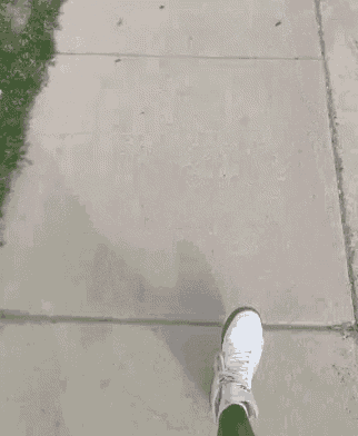 a manhole cover on a sidewalk with a circle on it