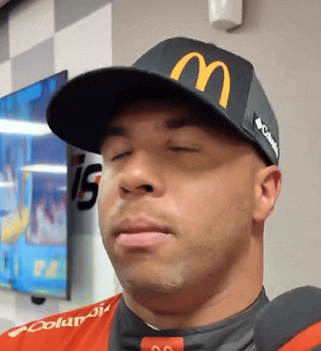 a man wearing a mcdonald 's hat is making a face