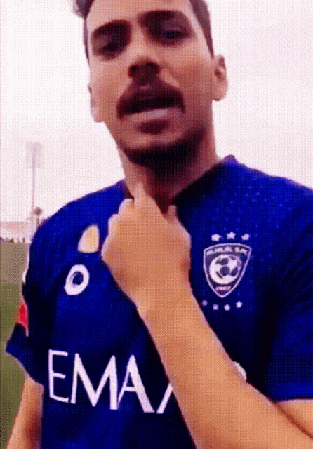 a man in a blue shirt that says ema on it
