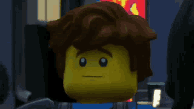 a close up of a lego man 's face with brown hair