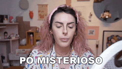 a woman with pink hair is looking at her face through a magnifying glass and says po misterioso .