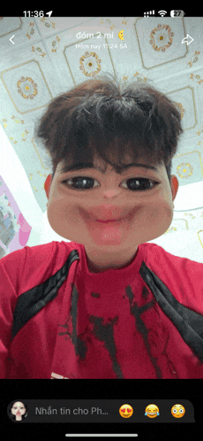 a phone screen shows a picture of a man with a funny face