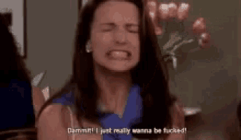 a woman with long hair is sitting in a chair and says `` dammit i just really wanna be fucked '' .
