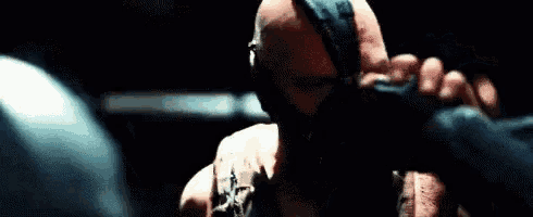 a close up of a man wearing a mask and gloves .