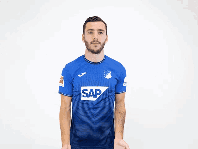 a man wearing a blue shirt with the word sap on the front