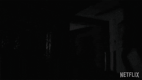 a man is standing in a hallway with a netflix logo on the bottom right