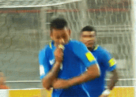 a man in a blue shirt is eating a ice cream cone