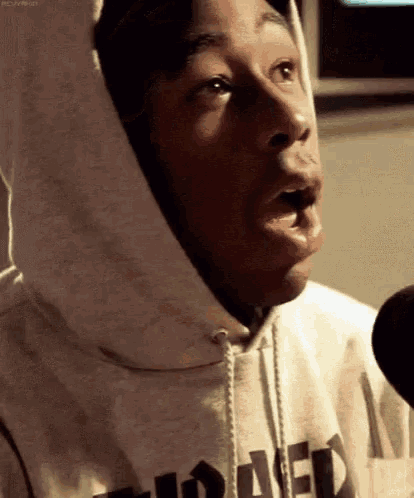 a man wearing a hoodie with the word thrasher on it