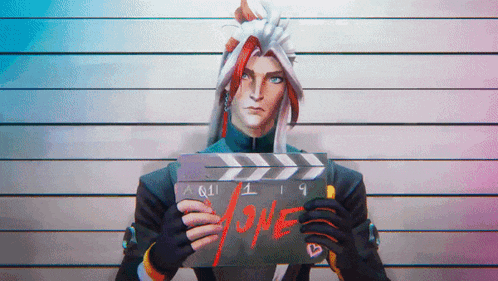 a man is holding a clapper board with the word one written on it