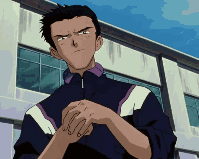 a man in a purple and white jacket holds his hands together