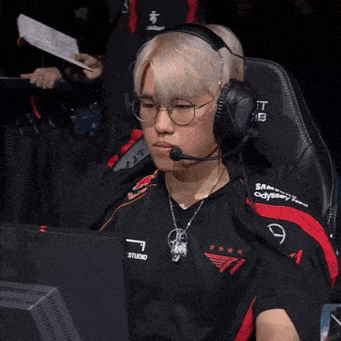 a man wearing headphones and a red bull jersey