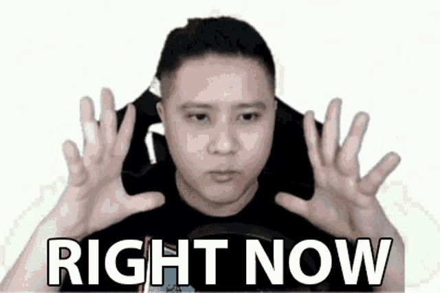 a man is making a funny face with his hands and the words `` right now '' written next to him .