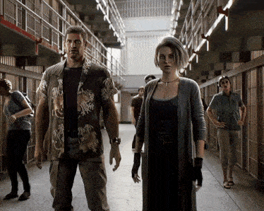 a man and a woman are walking down a hallway