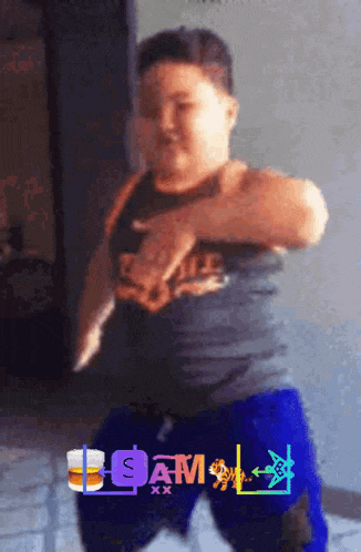 a young boy is dancing in front of a sign that says sam xx