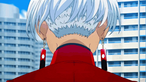 the back of a person 's head with a red jacket and earrings