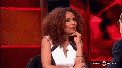 a woman with curly hair is talking to a man on a television show called cole