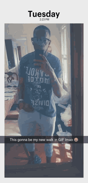 a man taking a picture of himself in front of a mirror on tuesday