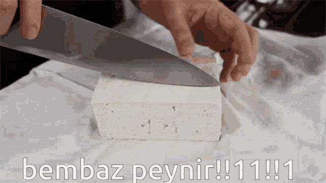 a person is cutting a piece of cheese with the words bembaz peynir !!! 11 !!! written below them