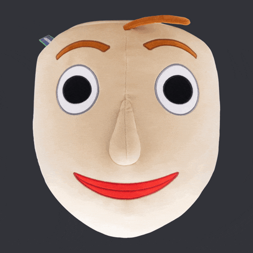 a stuffed toy that looks like a face with big eyes