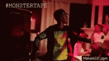 a person is dancing in a dark room with the words monstertape written on the bottom