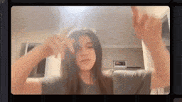 a young woman is taking a picture of herself in a video call .